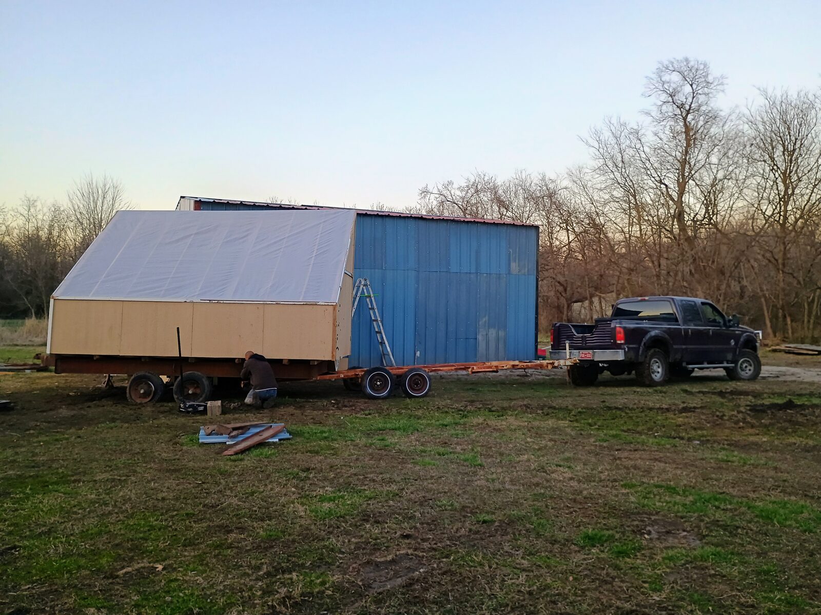 Kiln hitched to the truck, someone working near the wheels